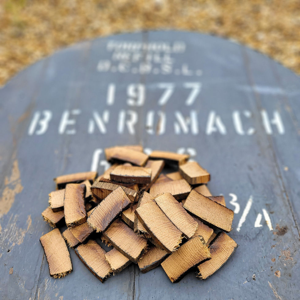 Close view of rough-cut Benromach 1977 barrel stave pieces with original source-cask markings