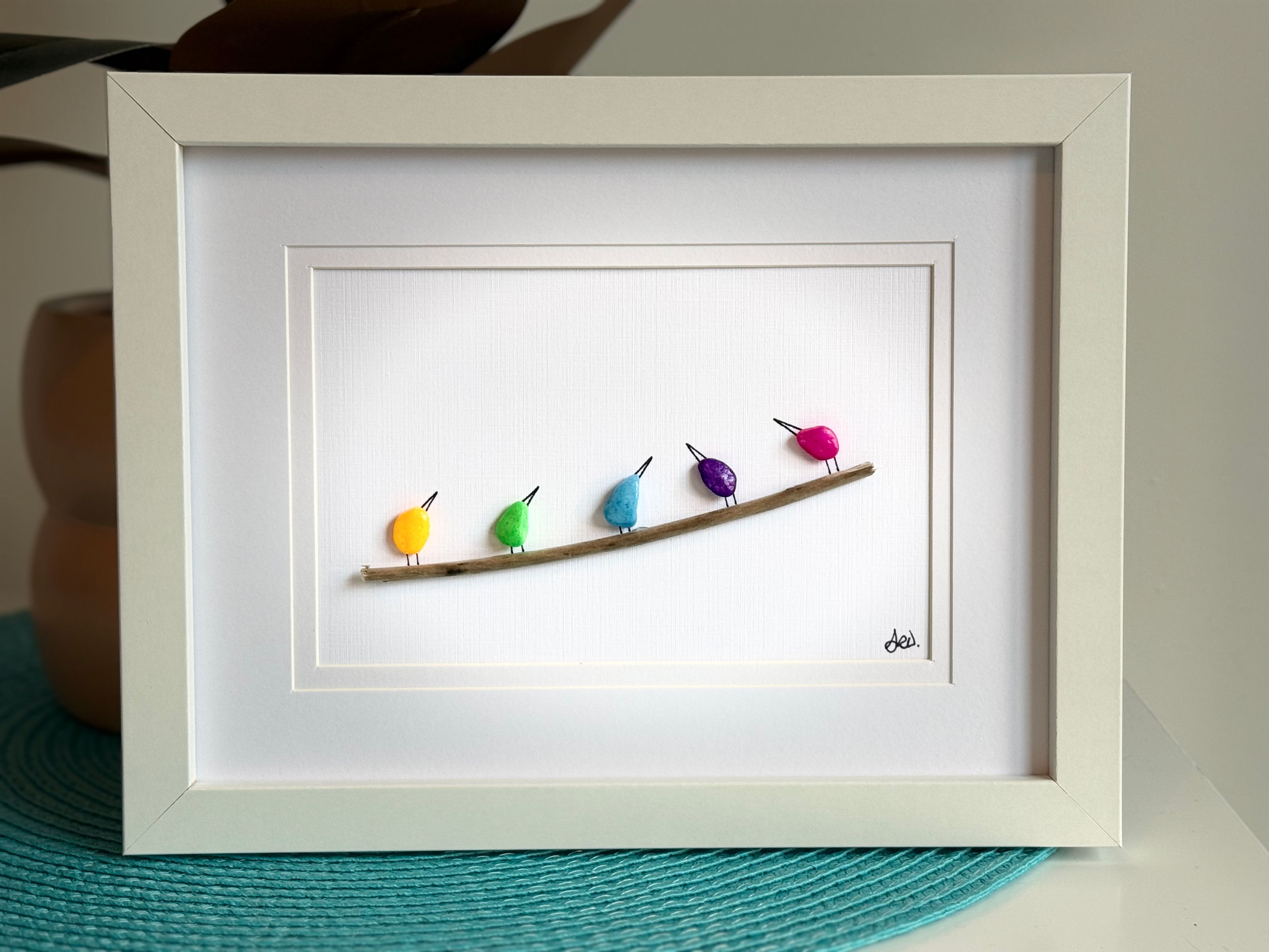 Bright coloured birds on stick