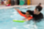 Swimming teacher with student.