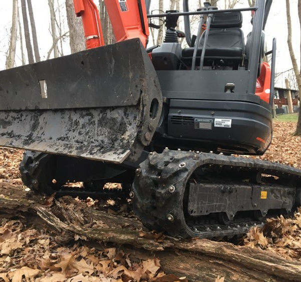 Carbide studs on a Mini Excavator
