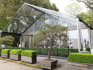 Front view of custom tent structure surrounded by lush greenery at Filoli