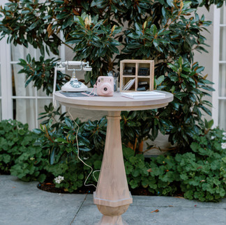 Vintage-inspired wedding guestbook table with rotary phone and Polaroid camera setup
