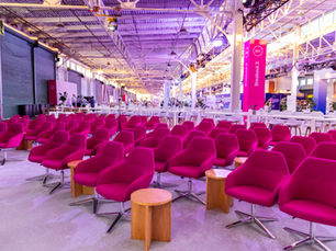 Magenta seating in corporate breakout session with wood side tables