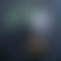 Lavender gin sour and pineapple margarita with floral details on a black cocktail table