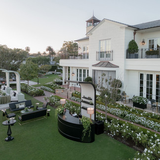 Designer lounge furniture in black and green tones set up on lawn for upscale cocktail area