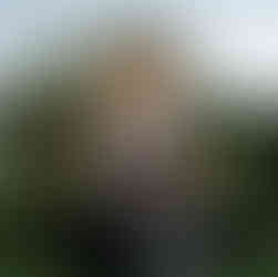 Black bar with curved arch, backlit pattern wall and floral accents at luxury outdoor event