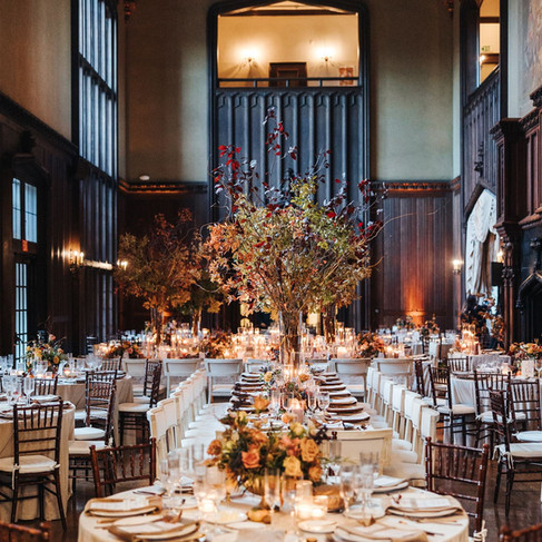 Overhead view of fall wedding rentals and long banquet tables inside historic venue