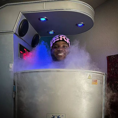 Smiling man in cryotherapy chamber with cold vapor