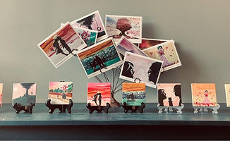 Artistic cards displayed on stands and a wire tree.