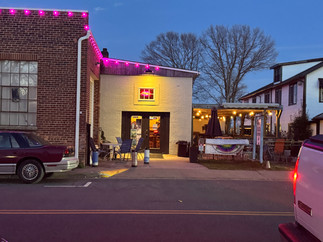 Small business with outdoor seating lit at night