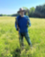 Mike Block holding up a Milkweed showing the root. Photo by Beth Stenstrom.