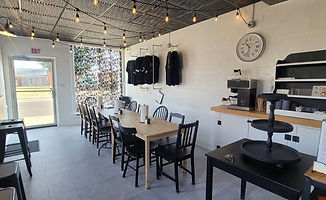 Modern cafe interior with large wooden communal table.