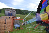 Person operating burner to inflate hot air balloon