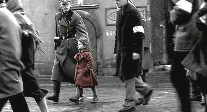 A little girl in a red coat walks alongside a German officer
