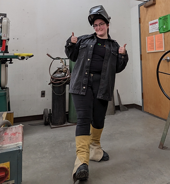 Lily in welding mask with thumbs up