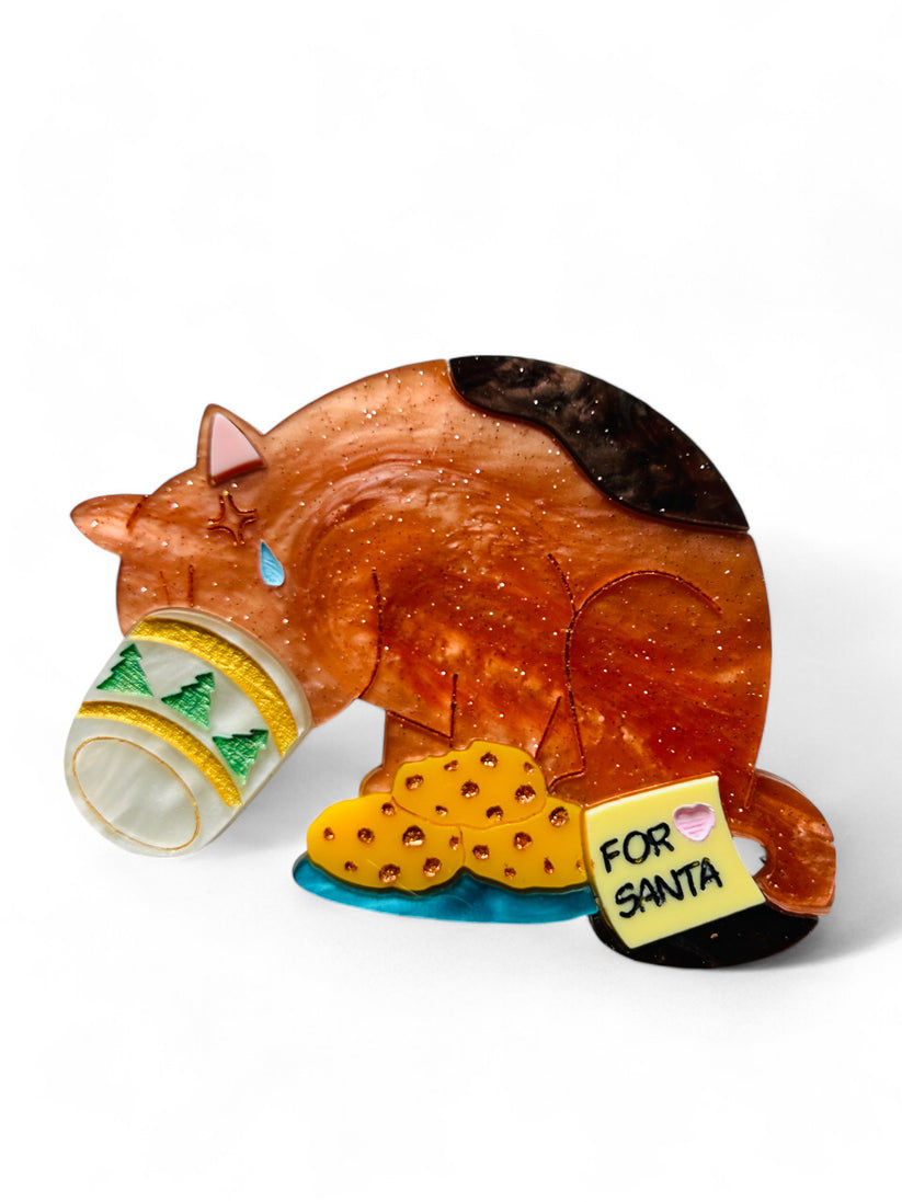 Cat stuck in Santa's cup brooch