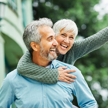 Smiling senior couple with implants
