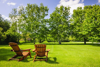 Two chairs on green lawn