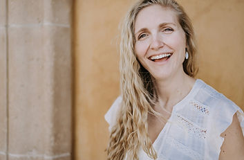 middle aged blond woman in white summer top.jpg