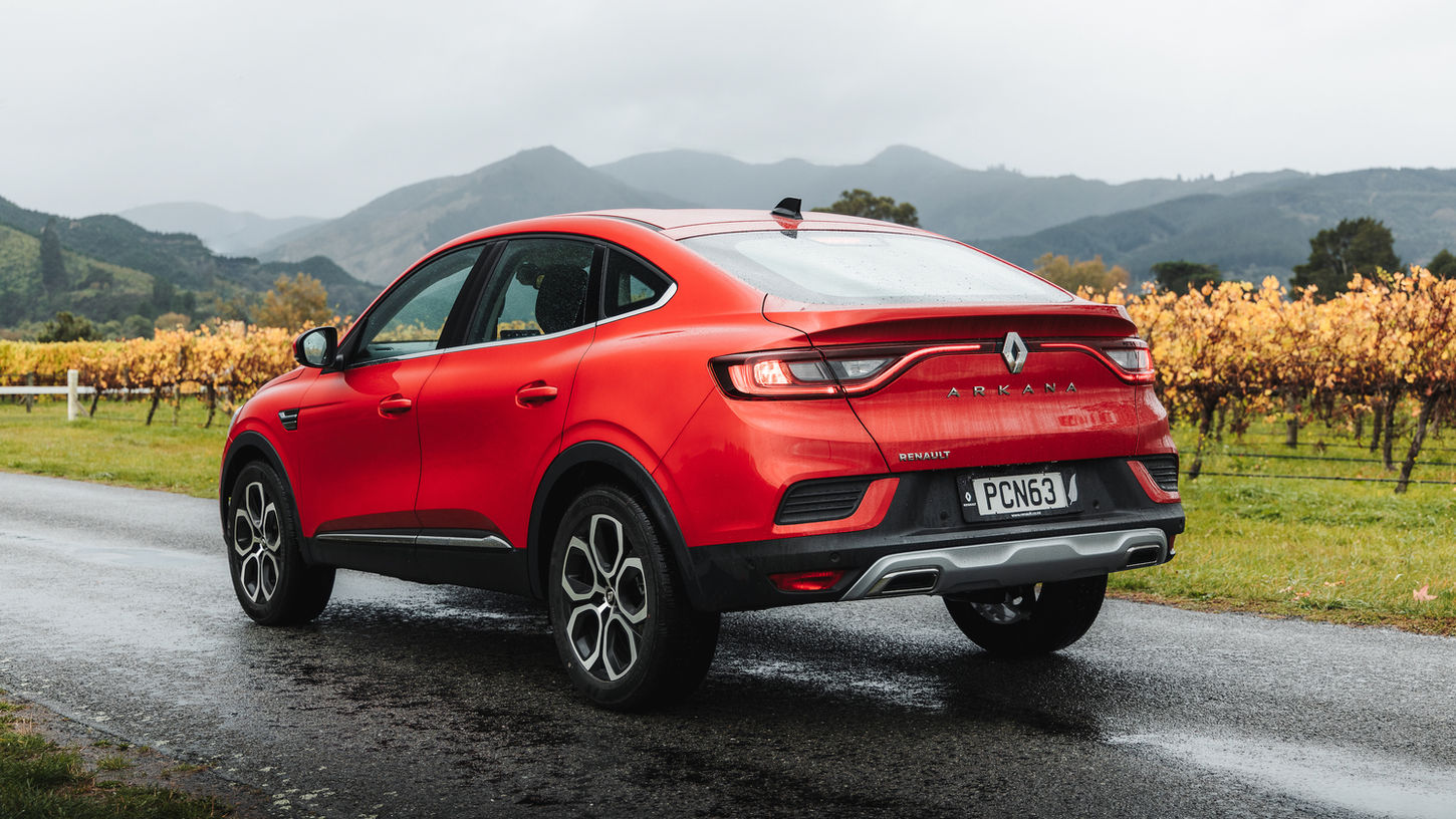 Red 2022 Renault Arkana driving by vineyards, near Picton, New Zealand (1)