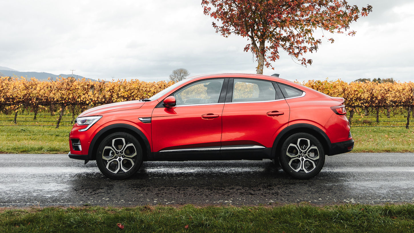 Red 2022 Renault Arkana driving by vineyards, near Picton, New Zealand (2)