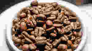 Medium roasted whole coffee beans on plate