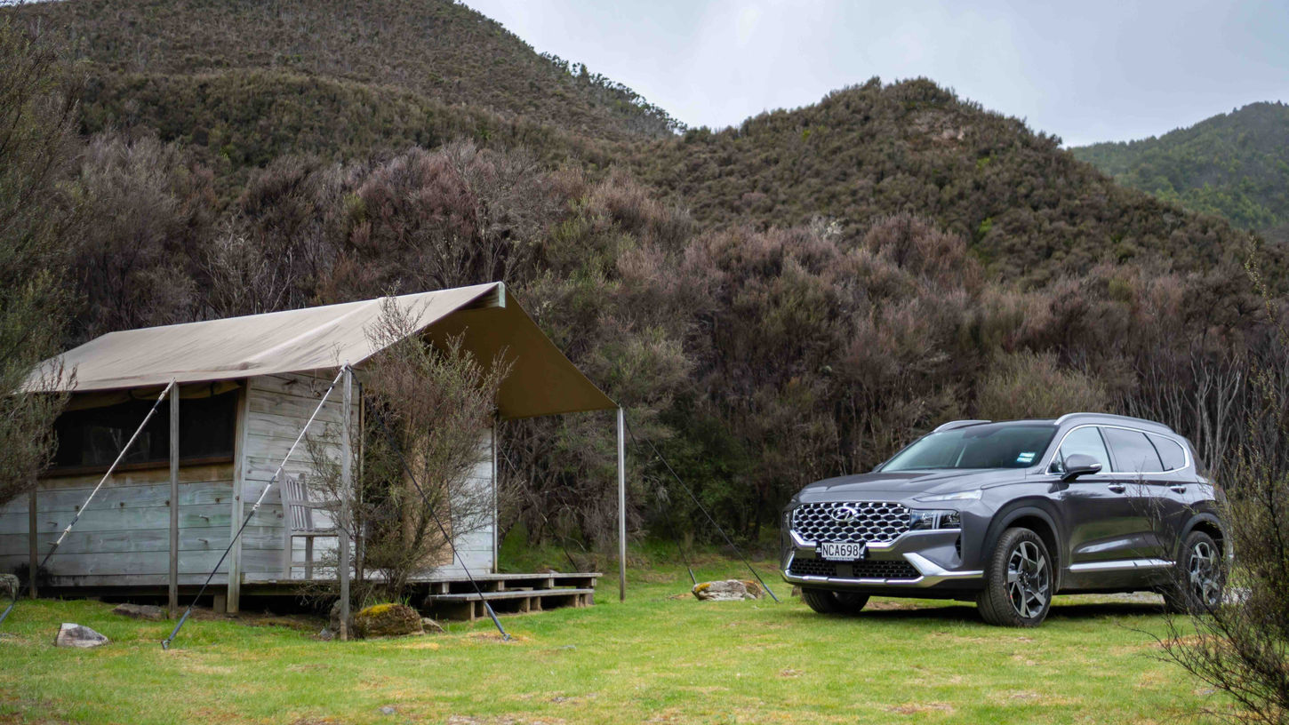 2021 Hyundai Santa Fe parked on grass in front of camping tent