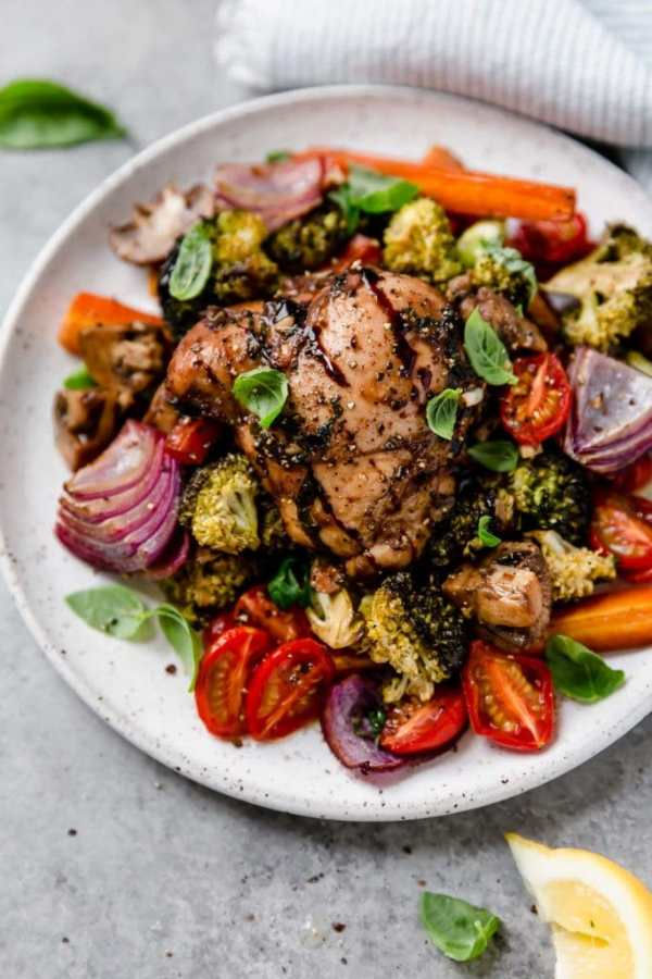 A colorful image of One-Pan Balsamic Chicken Veggie Bake plated on white plate.