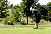 Golfer putting on green