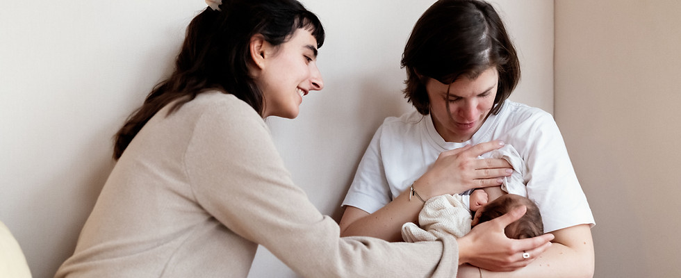 Doula Léa hält zärtlich den Kopf des Babies einer frisch gebackenen Mama