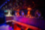 Stylish private venue with velvet seating and mirrors.