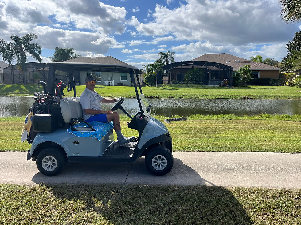  The author's husband in a golf cart with an alligator in the background, humorously emphasizing his readiness to protect her