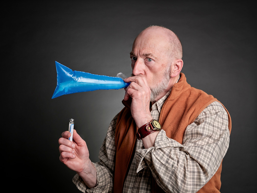 A man performing the SIBO breath test