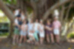Family reunion under large fig tree.