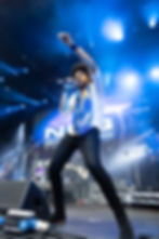 lead singer on stage at music festival.