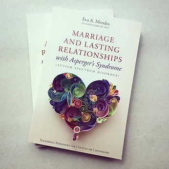 Quilled paper artwork “Love Is All Around,” Sena Runa’s signature design, featured on the cover of Eva A. Mendes’s book Marriage and Lasting Relationships with Asperger’s Syndrome. Intricate colorful paper coils form a heart-shaped design symbolizing love and connection.