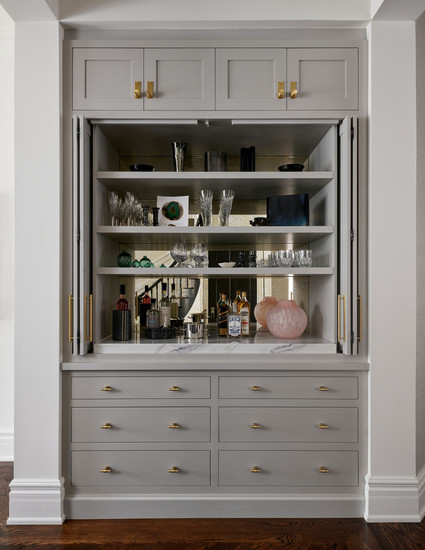 Built-in custom cabinetry dining room hutch doors open, mirror backsplash