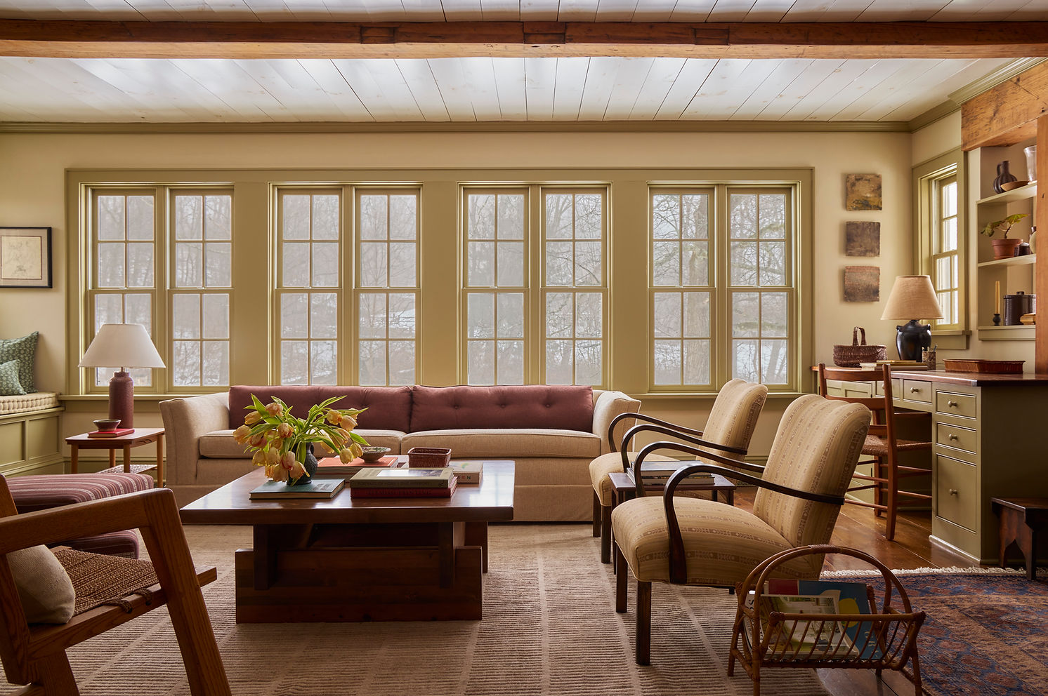 Layered living room interior in a Ridgefield, Connecticut home with vintage furniture, artwork, and natural light.