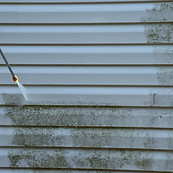 Pressure washing UPVC cladding.