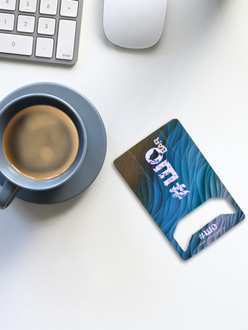 Unique blue business card design beside a coffee cup, keyboard and computer mouse