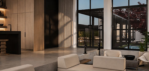 Open-concept living space at Monument House with expansive glass walls and modern architectural detailing.