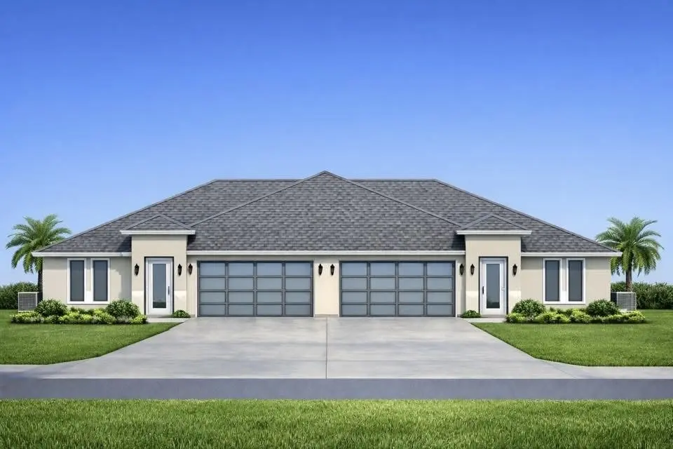 Traditional luxury home with stone exterior, symmetrical design, bay windows, gabled rooflines, columned entryway, and manicured front landscaping.