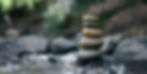 Stack of zen stones, Close up of pebble rocks stacked on top of each other in stream leadi