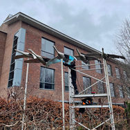 stainless steel bird ornaments flying in the air, while being welded in front of a business park