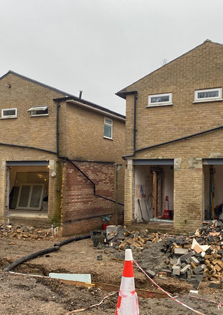 These two very average looking houses are now in the process of being transformed. Their little back yards and fencing have been removed and foundations have been created.