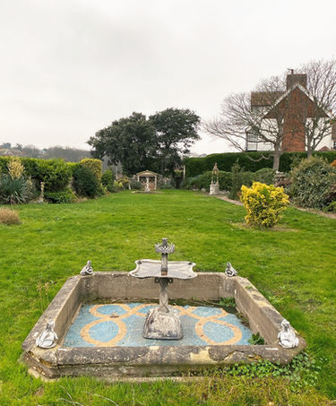 The acre plot has lots of statues in the garden.