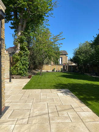 The patio extends around the back of the house and shows off the approx 120ft x 50ft garden.