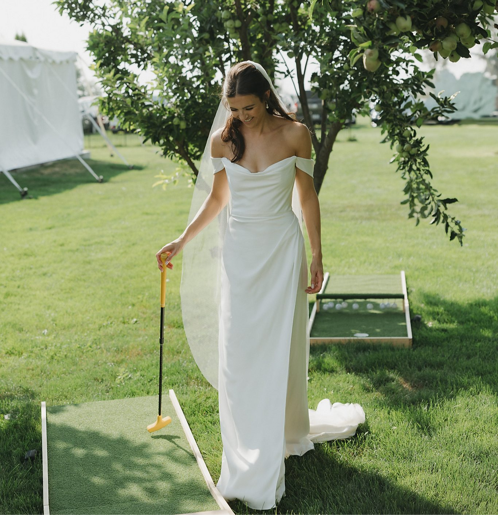Bride playing mobile mini golf for wedding cocktail hour at outdoor venue in Boise Idaho