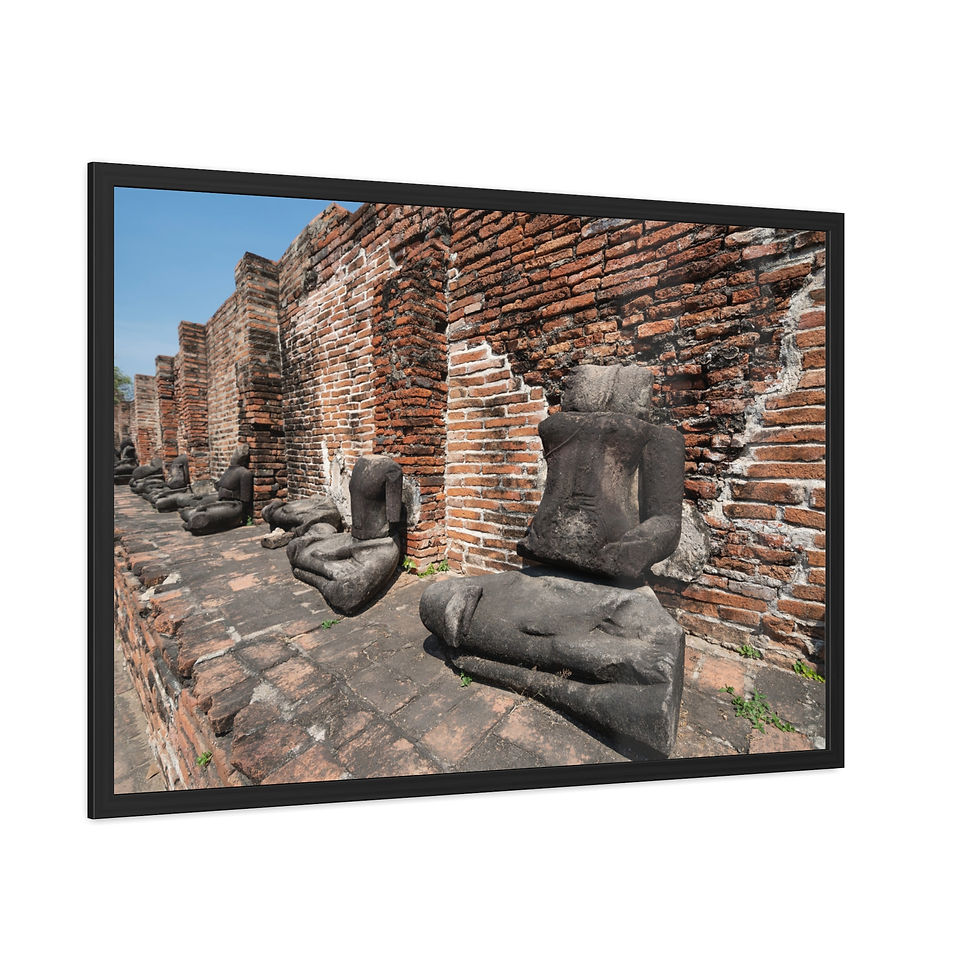 Thumbnail: Ancient headless Buddha statues line old brick wall ruins under blue sky.