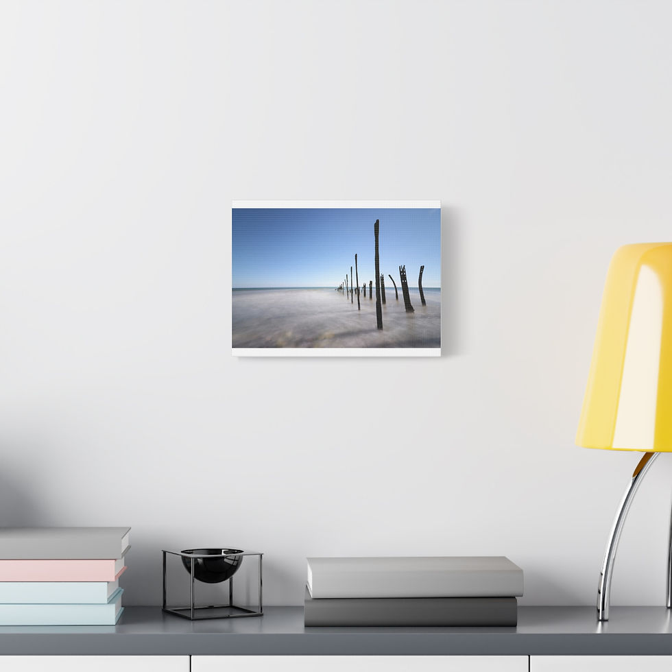 Thumbnail: Coastal landscape canvas print: Weathered wooden pilings in shallow water, blue sky.